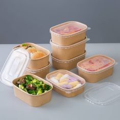 six plastic containers with food in them on a table