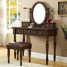 a dressing table with a mirror and stool in front of it on top of a hard wood floor