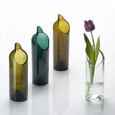 three different colored vases with flowers in them