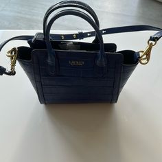 New Ralph Lauren Blue Small Handbag Tote Purse. $195. So Cute! Height: 6”. Width: 9.5”. Depth: 3”. Designer Blue Handheld Satchel, Blue Handheld Satchel For Errands, Blue Handheld Bag With Gold-tone Hardware, Blue Handheld Bags With Gold-tone Hardware, Classic Blue Bags With Handles, Blue Top Handle Bag With Branded Hardware, Blue Formal Satchel With Branded Hardware, Ralph Lauren Rectangular Shoulder Bag With Gold-tone Hardware, Everyday Ralph Lauren Bags With Gold-tone Hardware