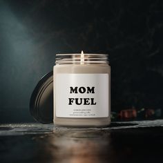 a candle with the words mom fuel on it