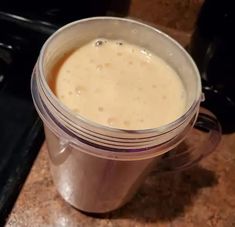 a blender filled with liquid sitting on top of a counter next to a stove