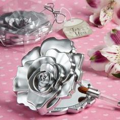 a baby's first birthday gift set with a silver rose in the center and a bottle opener