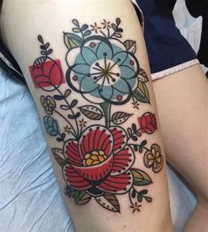 a woman's thigh with flowers on it and the words tattoobod follow