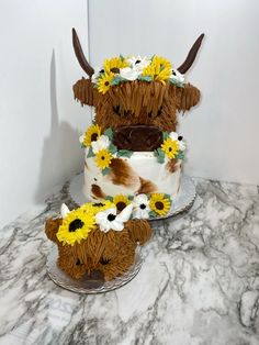 two tiered cake decorated with sunflowers and cattle heads