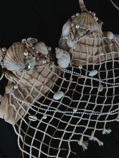 two bags with seashells and pearls on them