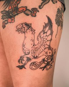 a close up of a person's thigh with tattoos on it and an eagle