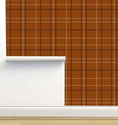 a wall with a brown and white plaid pattern on it, next to a window