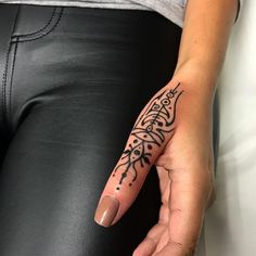 a woman's hand with a tattoo on her left arm and the word love written in black ink