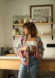 a woman holding a cup in her hands