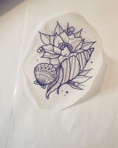 a white plate with blue designs on it sitting on top of a paper towel next to a pen and ink drawing