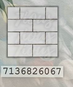 a white brick wall with the number and name on it