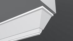 the corner of a white shelf against a gray background