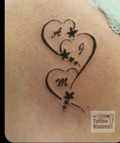 a tattoo with two hearts and butterflies on it