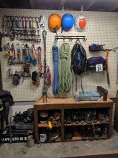 there are many items on the wall in this garage, including shoes and other sports equipment