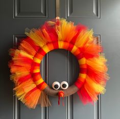 an orange and yellow wreath with googly eyes