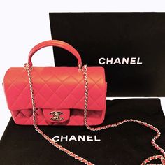 Chanel Red Lambskin Mini Rectangular Top Handle Flap This stunning Chanel mini flap top handle bag is a timeless and chic accessory that is perfect for any occasion. The bag is crafted from luxurious lambskin leather in a beautiful red color. The bag features a leather top handle, a gold chain link shoulder strap threaded with leather and a frontal flap with a gold Chanel Classic CC turn lock. This opens to a leather interior with zipper and patch pockets. Designer: Chanel Material: Lambskin leather Origin: Italy Date/ Code: Microchip Production Year: 2022 Measurements: 7.75" x 4.75" x 2.25" (wxhxd) Drop: 1.5" handle; 22" strap Closure/Opening: CC turn-lock Interior Lining: Leather; Fine textile Hardware: Light gold-tone metal Includes: Chanel box, dust bag, ribbon & Entrupy COA Overall Co Red Designer Bag With Double Flap, Red Designer Bags With Double Flap, Designer Red Double Flap Bag, Red Formal Bags With Double Flap, Evening Flap Bag With Soft Leather And Double Flap, Luxury Double Flap Evening Bag In Soft Leather, Soft Leather Double Flap Evening Bag, Elegant Double Flap Soft Leather Bag, Elegant Double Flap Bag With Top Carry Handle