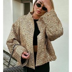 This chic, golden tweed jacket with sequins adds an elegant touch to any look. An effortless way to dress up any casual outfit while keeping you comfortable and stylish. An absolute must-have for every fashionable woman. SPECIFICATIONS Decoration: Button Decoration: Pockets Decoration: Sequins Age: Middle Age Thickness: Standard Material: Polyester Style: High Street Hooded: No Origin: CN Brand Name: TRAFZA Season: Autumn/Winter Pattern Type: Solid Sleeve Length(cm): Full Outerwear Type: Jackets Trendy Gold Outerwear For Party, Trendy Gold Party Outerwear, Chic Sequined Outerwear For Evening, Chic Sequined Evening Outerwear, Chic Gold Long Sleeve Outerwear, Chic Embellished Outerwear For Fall, Gold Long Sleeve Tweed Jacket For Work, Chic Gold Outerwear For Spring, Chic Party Outerwear With Contrast Sequin