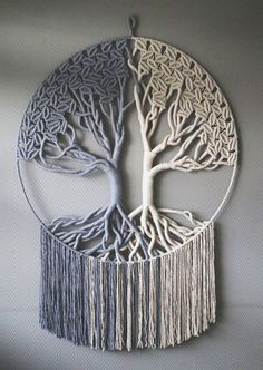 the tree of life is made out of metal wire and tasselled with fringes