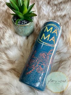 a blue can sitting on top of a fur covered floor next to a potted plant