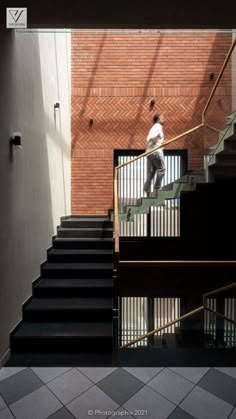 a man is walking up some stairs with his skateboard on the handrails