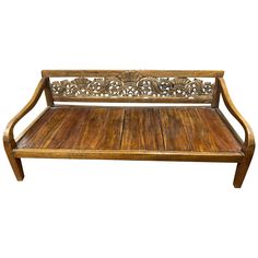 an old wooden bench with carvings on it