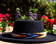 Dress up any hat with this western beaded leather hat band. Beautiful native patterns with vibrant colors. Bring a southern charm to your old favorites with this gorgeous hat band or make your new hat even more special. Made of full grain leather (highest grade leather) and glass beads. Handmade in Brazil by artisan women. You can match your hat band with our best-selling leather beaded dog collars! Treated with beeswax, water resistant. 30 days free returns or exchange. 1-year warranty. One siz Artisan Multicolor Hat Bands For Country Events, Southwestern Hat Bands For Festival With Flat Crown, Southwestern Style Hat Bands For Festival With Flat Crown, Artisan Hat Band With Flat Crown For Festivals, Southwestern Multicolor Hat Band For Country Events, Bohemian Festival Hat Bands With Flat Crown, Bohemian Flat Crown Hat Bands For Festivals, Bohemian Black Hat Bands For Ranch, Bohemian Black Hat Band For Western-themed Events