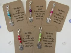 four tags with different colored beads on them and some sayings attached to the tags