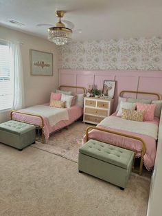 a bedroom with two beds, a dresser and a footstool in the corner