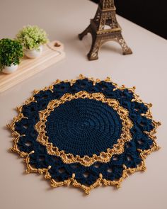 a crocheted doily with the eiffel tower in the back ground