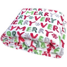 a white blanket with green and red letters on it, sitting next to each other