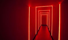 a long hallway with red lights in the middle