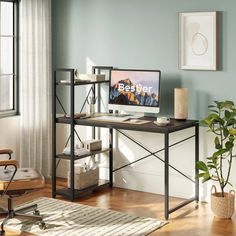 a desk with a computer on top of it in front of a window and potted plant