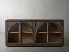 an old wooden cabinet with arched glass doors