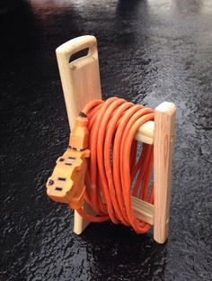 an orange hose is attached to a wooden stand