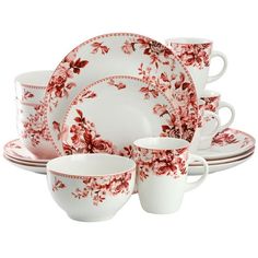 a red and white dinner set with flowers on it