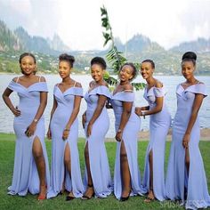 a group of women standing next to each other on top of a grass covered field