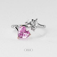 two heart shaped pink and white diamond engagement rings