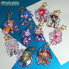 the cartoon keychains are all different colors and sizes, with characters on them