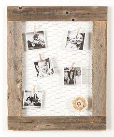 an old wooden frame with photos hanging on it and clothes pins attached to the pegs