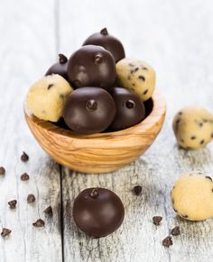 a wooden bowl filled with chocolate chip cookies