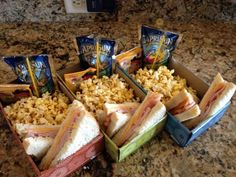 sandwiches and popcorn are sitting on the counter