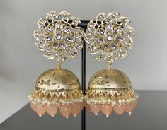 Peach Kundan Jhumka Earrings. Stylish Fancy Party Wear Jhumka Earrings .   Height: 3 inch Width: 1.5 inch These Jhumka Ear Rings can be worn with all kind of traditional Outfits.These beautiful Earrings are handcrafted in brass alloy with pearl stones of very fine quality. Ideal Gift for Wife, Girls, Women, Girlfriend.Ethnic Wear. Can be worn for engagement and wedding parties.  Handcrafted pair of earrings. Gives traditional look. Indulge in it or gift it and watch the compliments flow! It is advisable to store jewelry in a zip lock pouch (air tight pouch), keep away from water perfume and other chemicals and clean it with dry and soft cloth. FREE SHIPPING!! Peach Earrings Indian, Pink Round Jhumkas For Wedding, Festive Pink Drop Jhumkas, Heavy Pink Jhumkas For Festivals, Traditional Pink Jhumkas For Eid, Pink Bollywood Style Dangle Jhumkas, Pink Bollywood Dangle Jhumkas, Pink Dangle Bollywood Jhumkas, Pink Festive Jhumkas For Parties