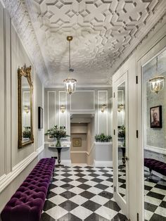 a hallway with white walls and black and white checkered floor