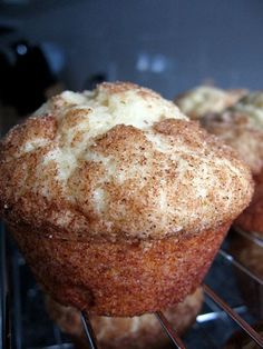 two muffins with powdered sugar on top