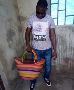 a man holding a colorful basket in his hand