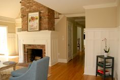 a living room filled with furniture and a fire place under a painting on the wall