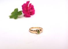 "Beautiful and unique solid gold ring signet ring set with pear-shaped peridot, alternative engagement or wedding ring. This wide 14K yellow gold ring is set with a pear-shaped light green peridot. The ring's wide design and the color of the peridot give this ring a certain air of majestic and quiet confidence. This ring is comfortable and noticeable and will be great for everyday use, as for a special occasion. It can also be a modern engagement ring. This ring will be a perfect gift for a stro Modern Gold Ring, Signet Ring Women, Pear Shaped Engagement Ring, Unique Nose Rings, Boho Engagement Ring, Peridot Engagement Rings, Stacked Rings, Signet Rings Women, Quiet Confidence