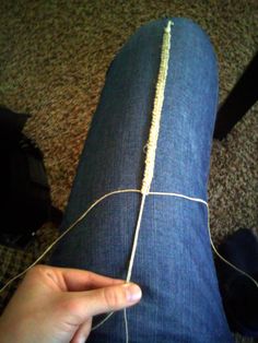 someone is holding the end of a pair of jeans that have been sewn together