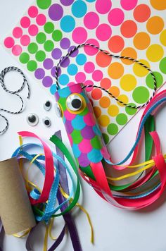 some craft supplies are laying out on a table with scissors, tape and other items